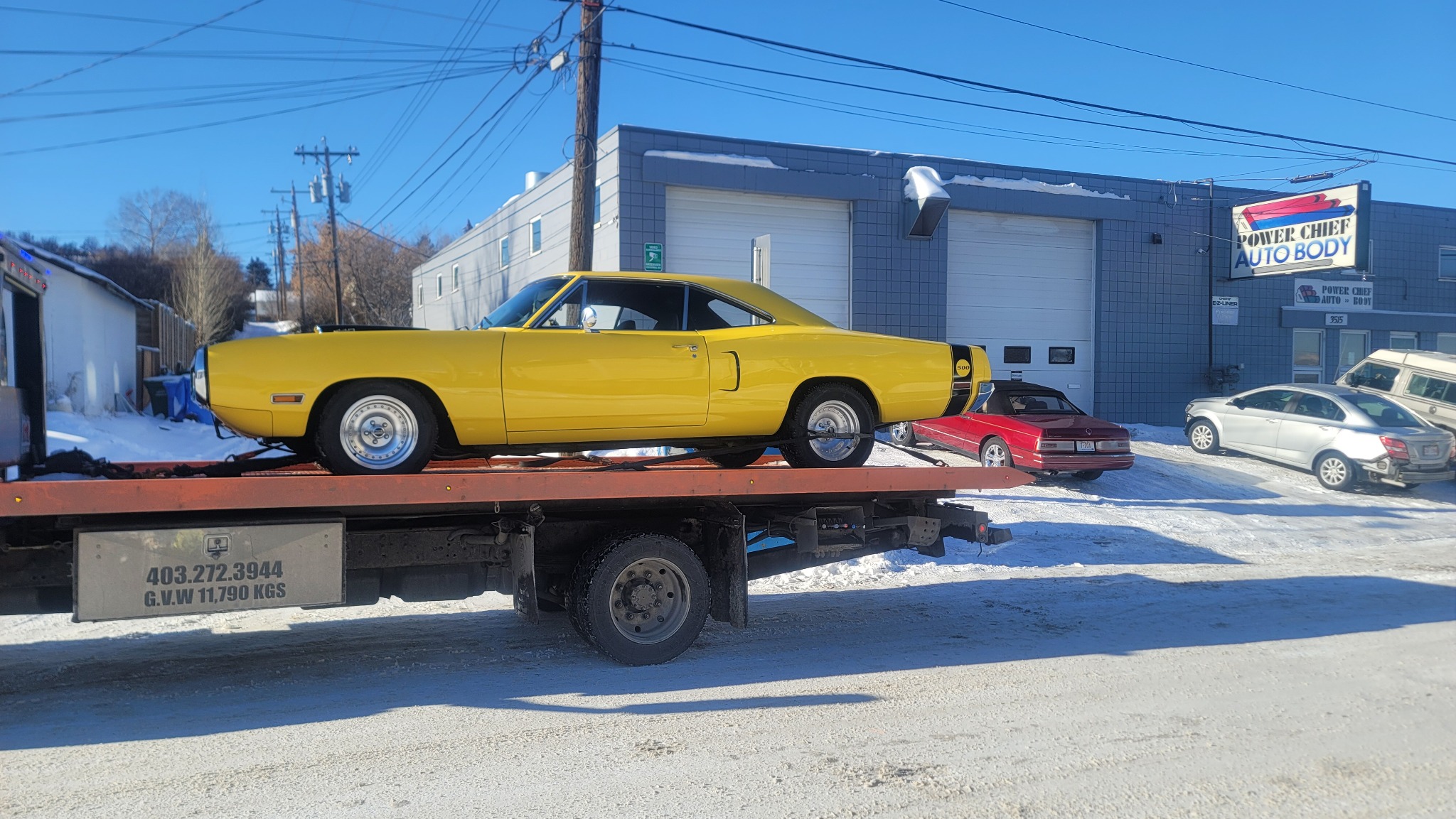 Side view of classic muscle car transported on flatbed