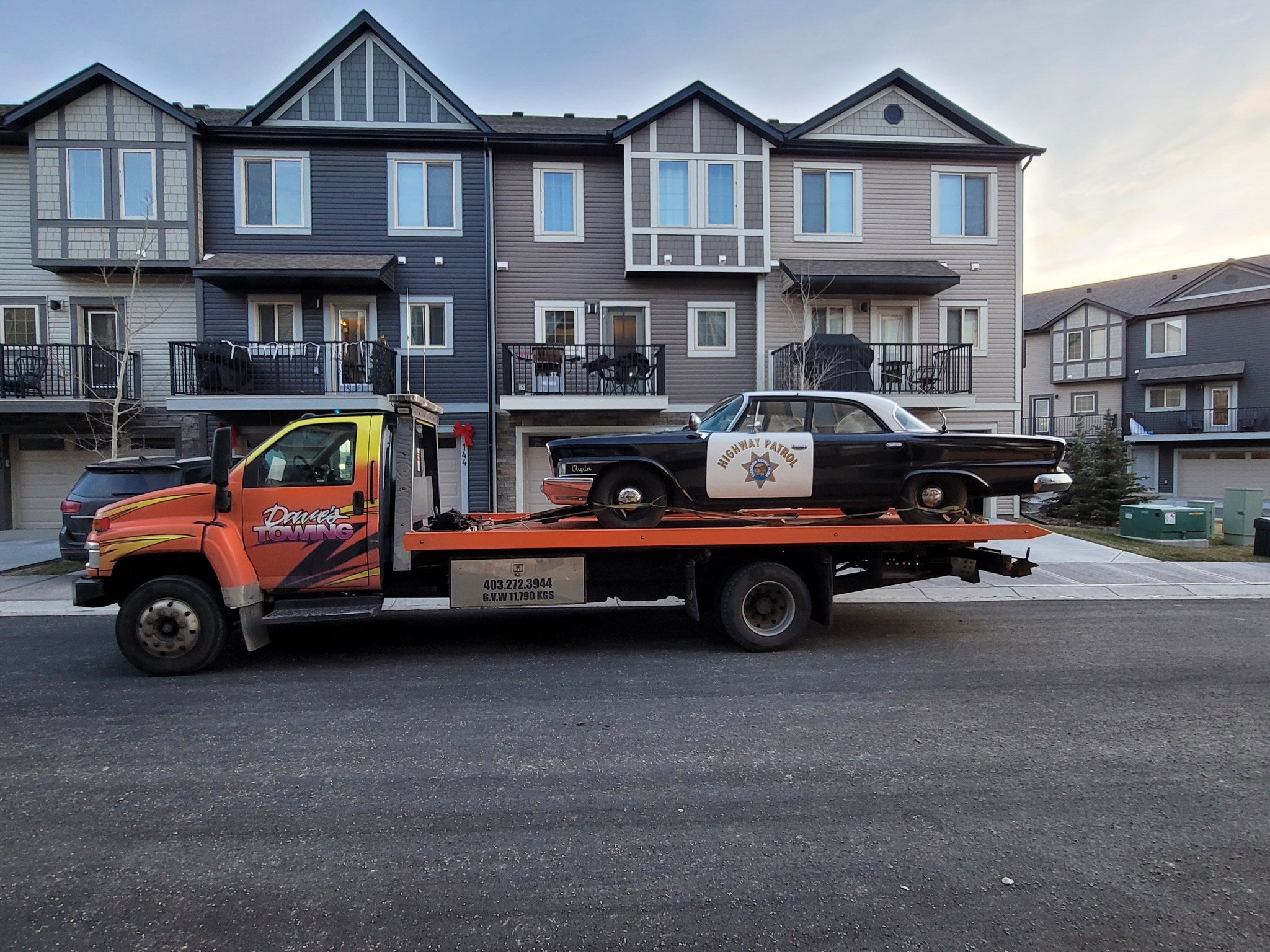 Vintage police car on flatbed tow truck