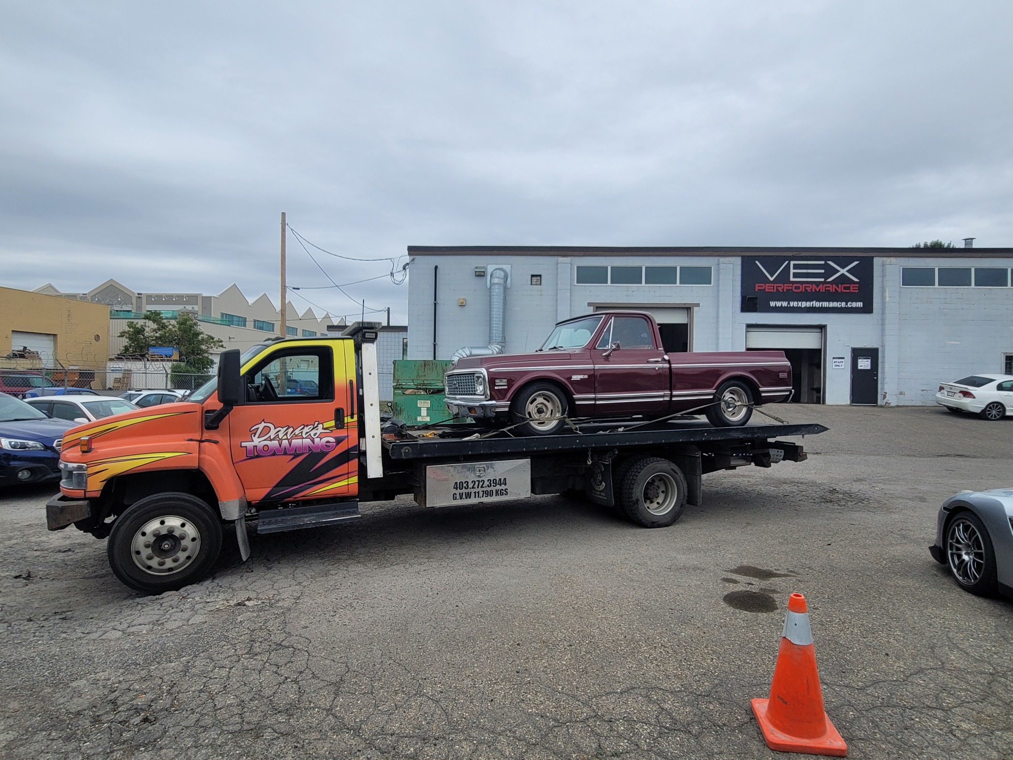 Medium duty flatbed towing a classic truck in Calgary